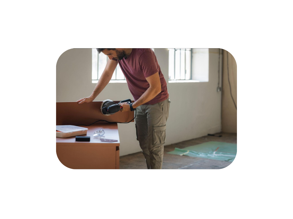 Craftsman finishing furniture at the Vogue Furniture Studio workshop