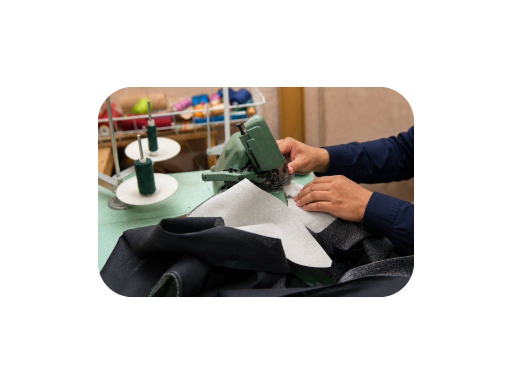 Upholstery artisan sewing at the Vogue Furniture Studio workshop